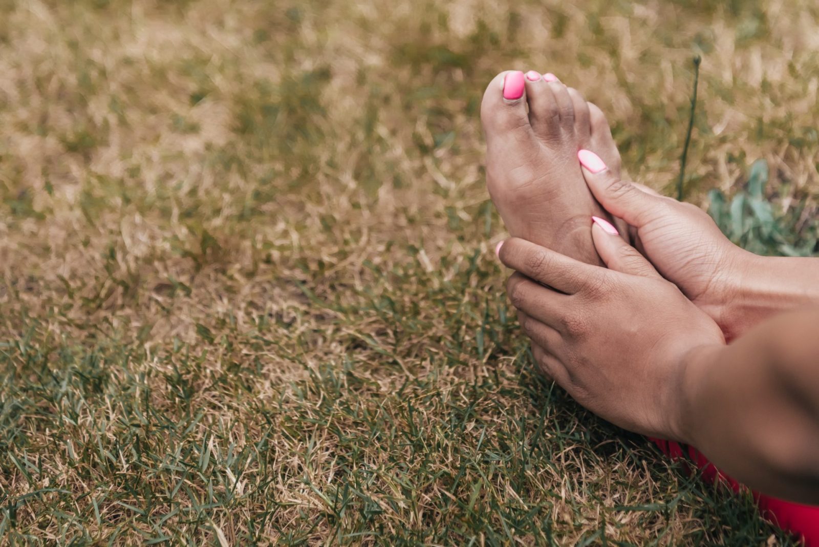 a close-up of someone caressing their feet, when are orthotics necessary