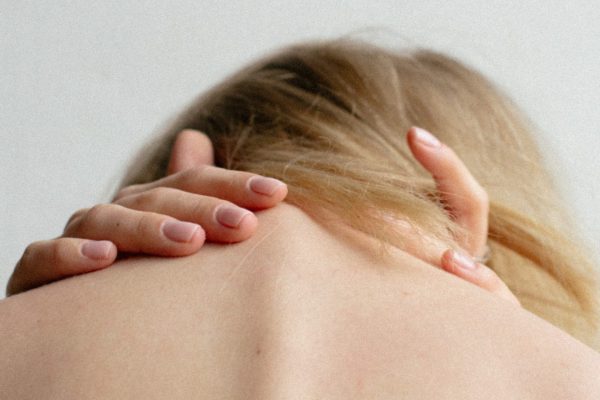 close up of woman clutching her spine