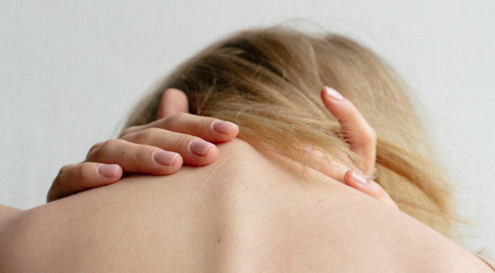 close up of woman clutching her spine