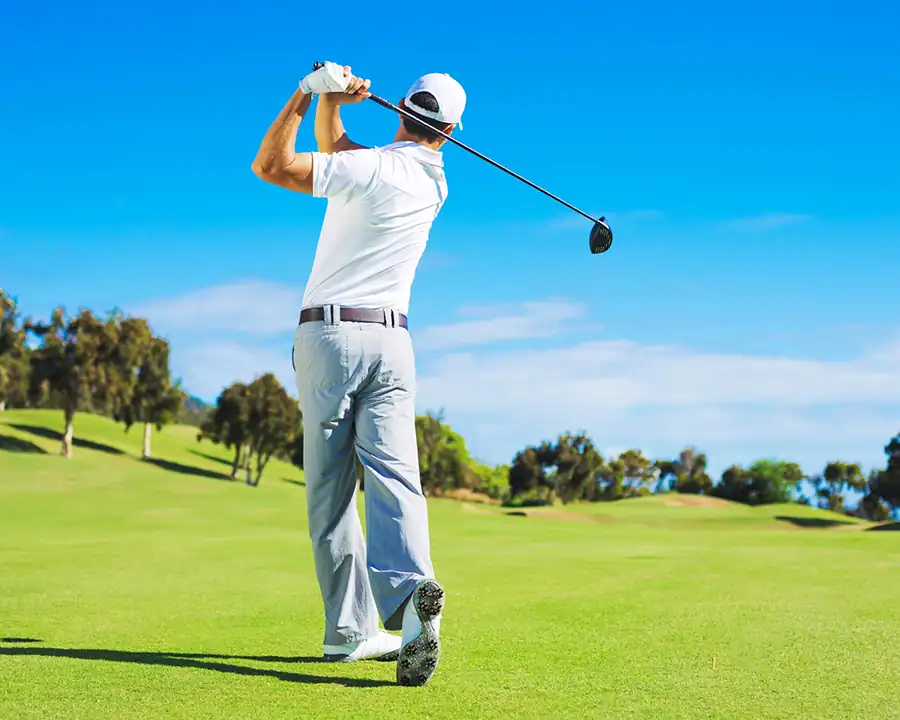 golfer driving the ball off a golf tee