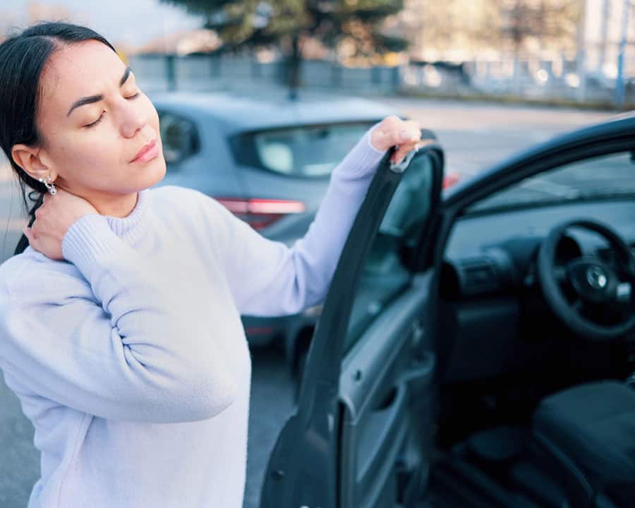 Woman suffering from neck injury after car crash