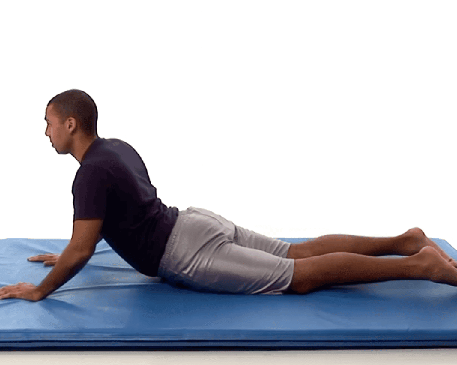 man demonstrating prone pressup on a blue mat