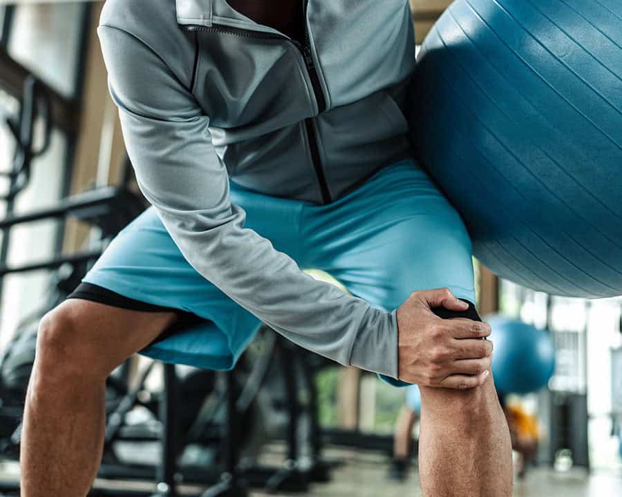 A man use pilates ball and hurt knee at gym. Fitness, gym, worko