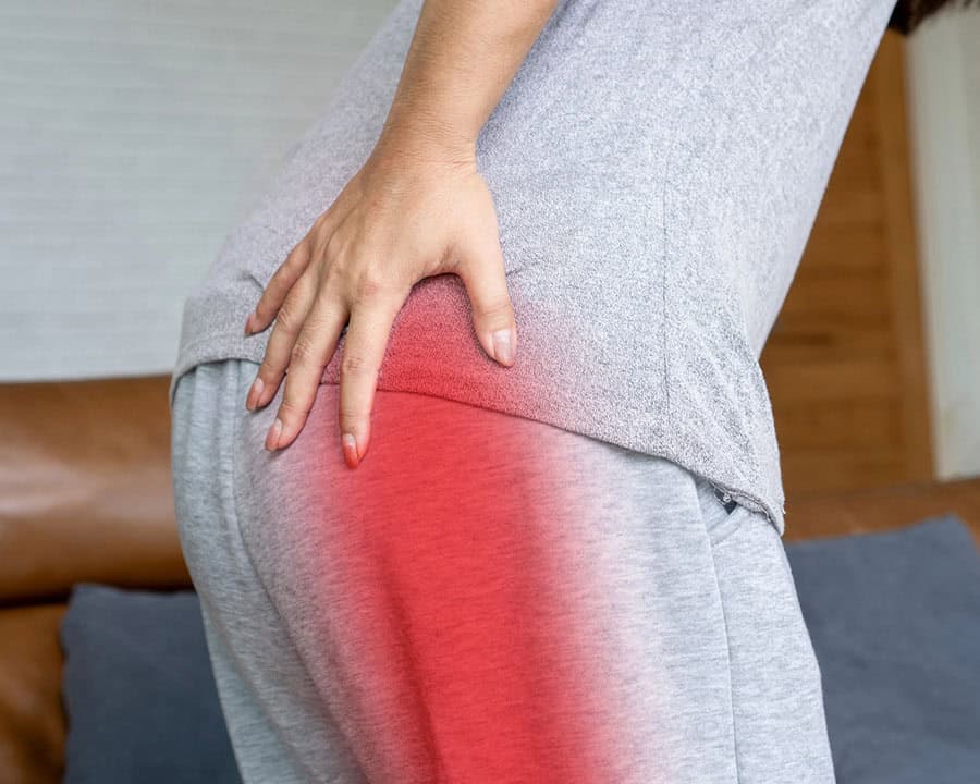 Sciatica Pain concept with woman suffering from buttock pain spreading to down leg , chronic pain from bad posture